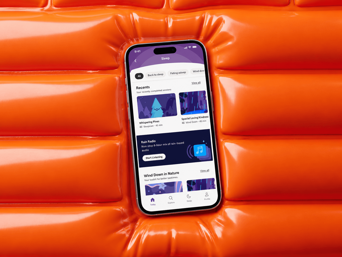 Headspace Sleep tab on a phone lying on an inflated orange surface